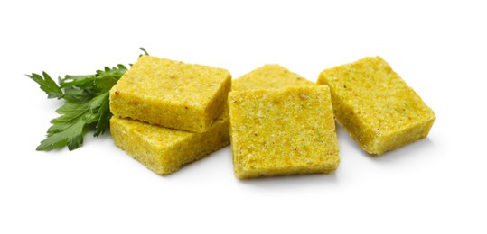 Photo of Tasty aromatic bouillon cubes and parsley isolated on white
