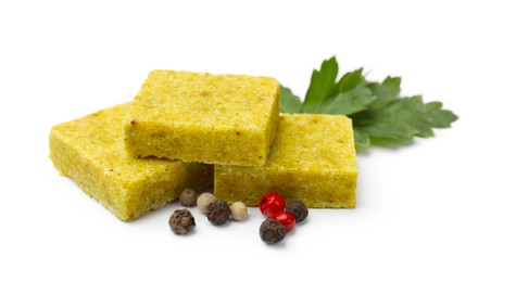 Photo of Tasty aromatic bouillon cubes, peppercorns and parsley isolated on white