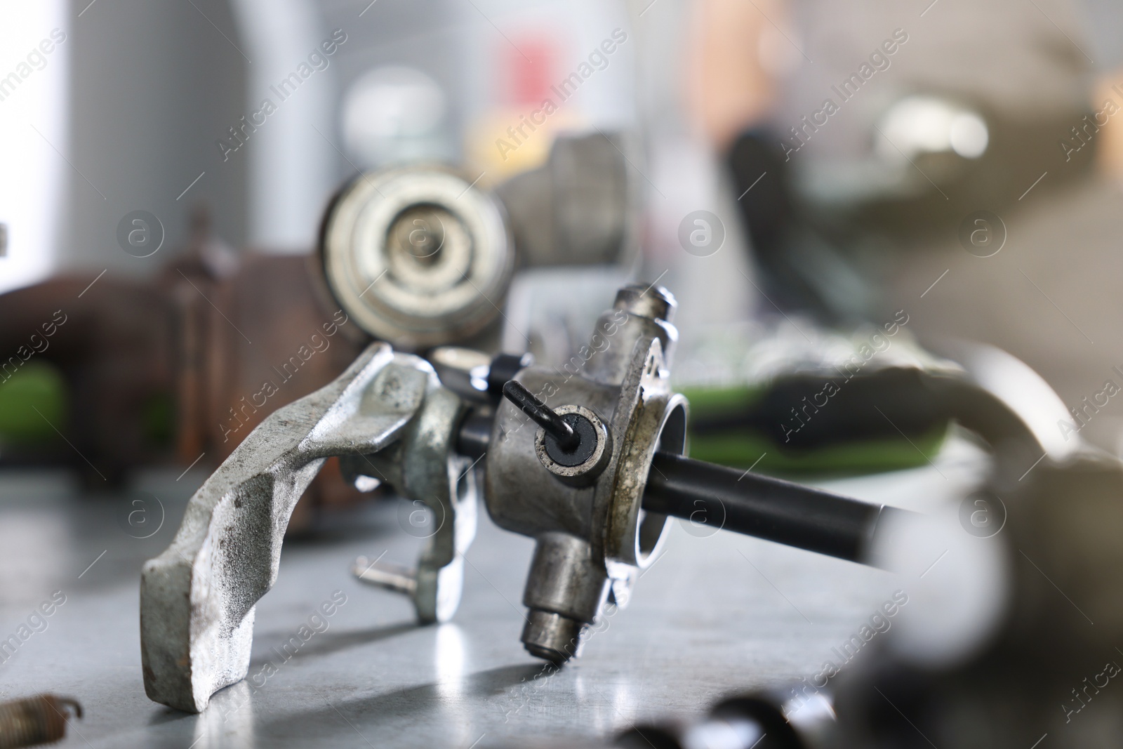 Auto part. Manual transmission on grey table indoors, closeup Photo of Auto part. Manual transmission on grey table indoors, closeup