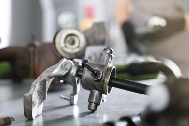 Photo of Auto part. Manual transmission on grey table indoors, closeup