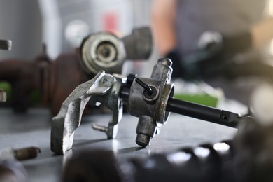 Photo of Auto part. Manual transmission on grey table indoors, closeup