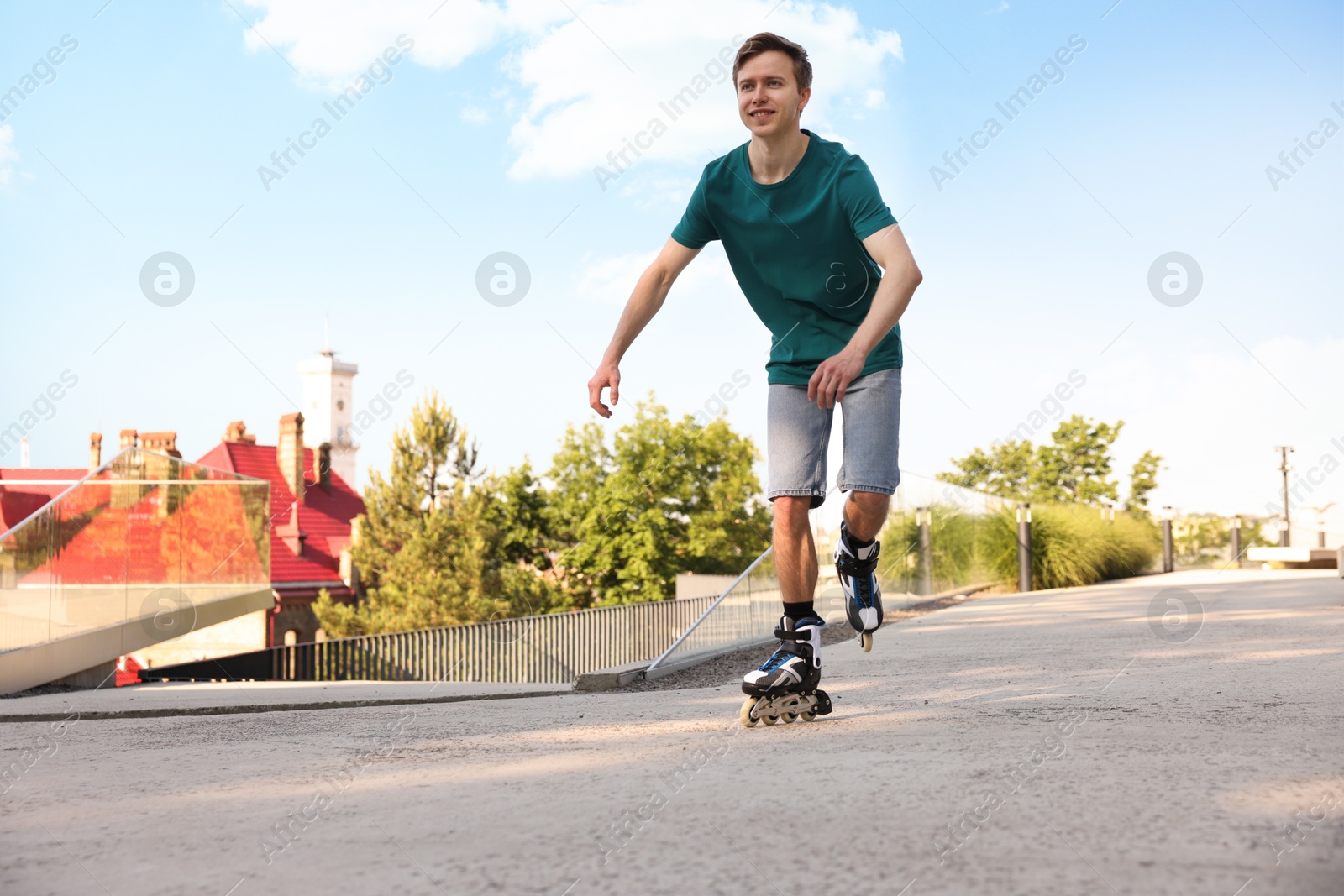 Happy man roller skating on city street. Space for text Photo of Happy man roller skating on city street. Space for text