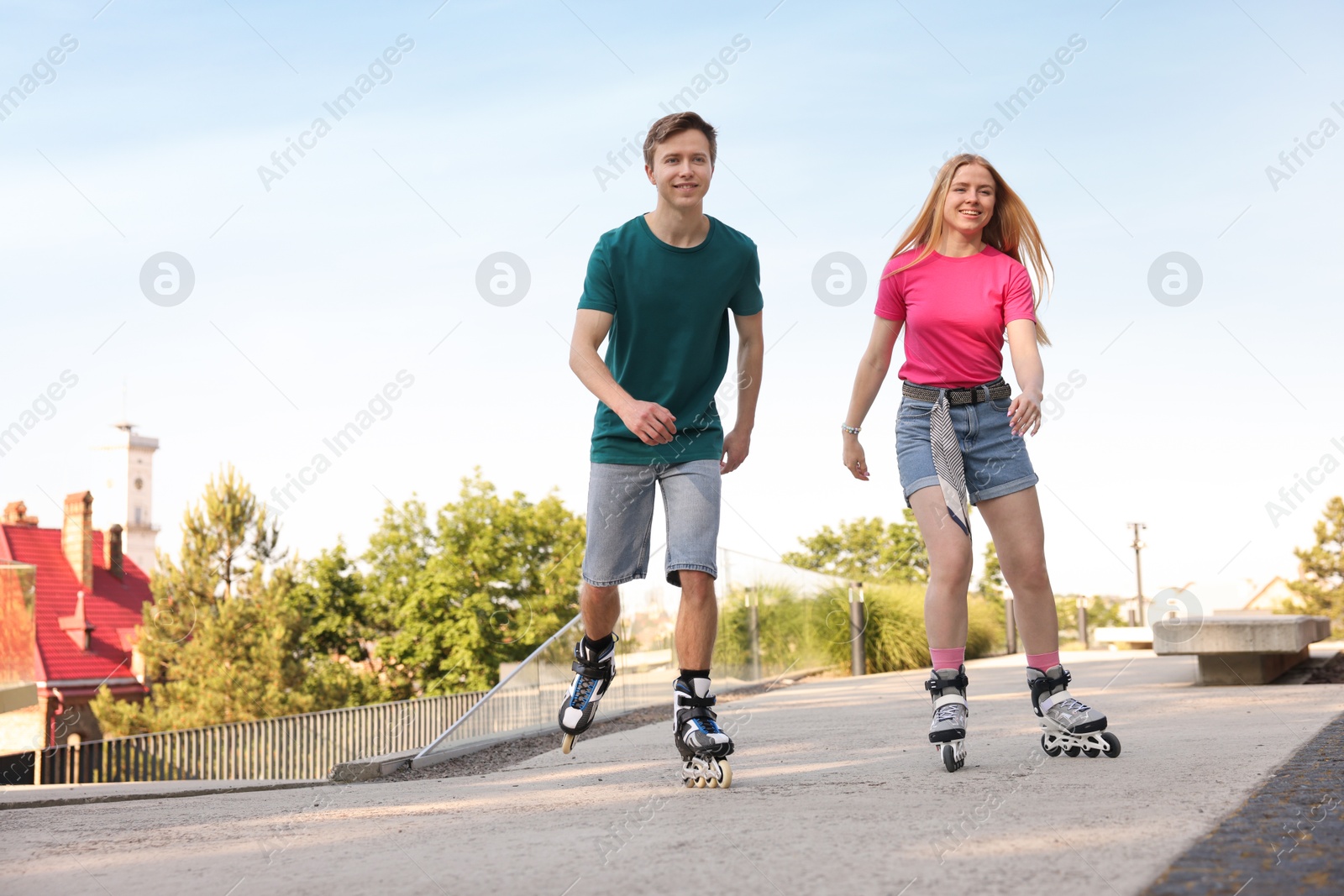 Photo of Happy couple roller skating together on street