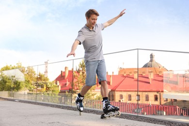 Photo of Happy man roller skating on city street