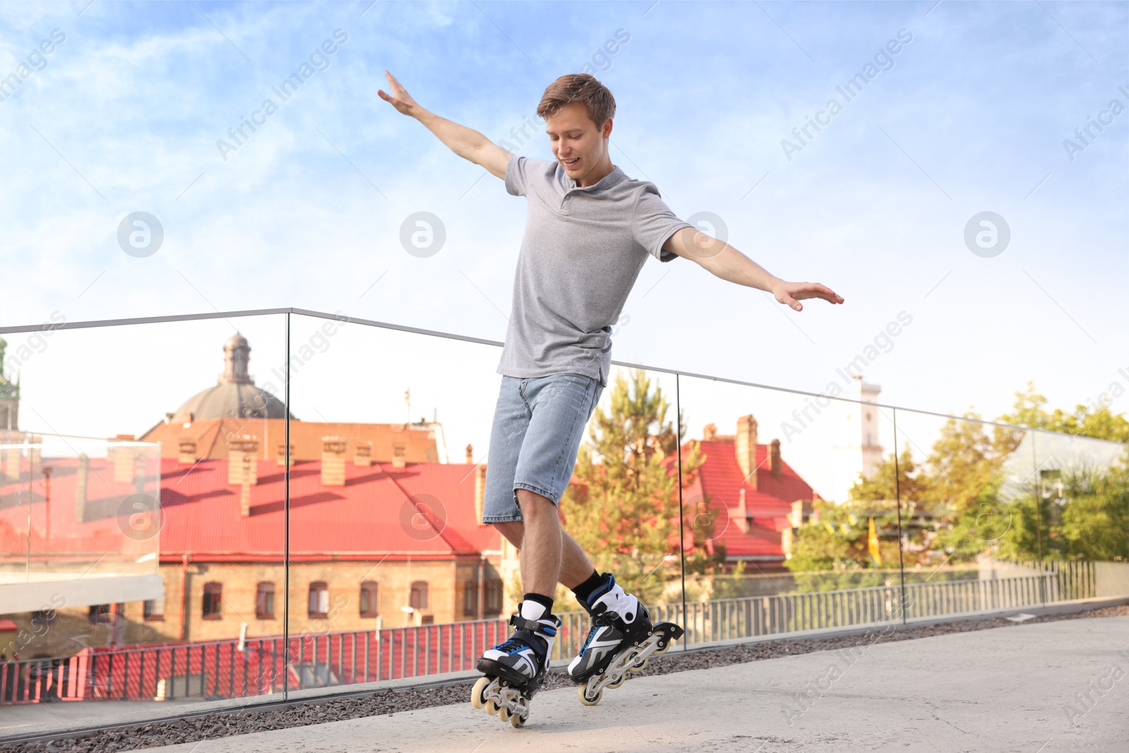 Happy man roller skating on city street Photo of Happy man roller skating on city street