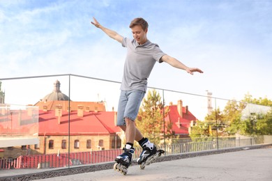 Photo of Happy man roller skating on city street