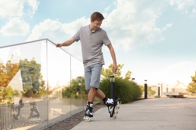 Photo of Happy man roller skating on city street