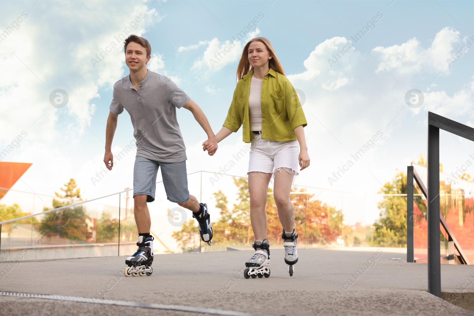 Photo of Happy couple roller skating together on street