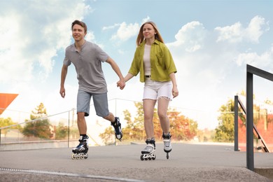 Photo of Happy couple roller skating together on street