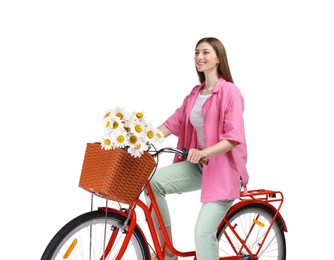 Photo of Smiling woman riding bicycle with basket of flowers against white background