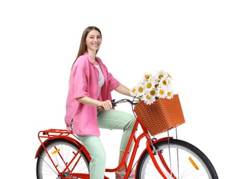 Photo of Smiling woman riding bicycle with basket of flowers against white background