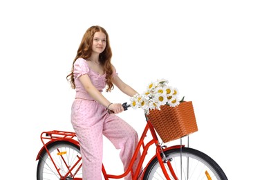 Photo of Beautiful teenage girl posing on bicycle with basket of flowers against white background