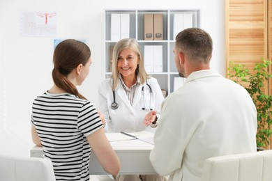 Photo of In vitro fertilization (IVF). Couple having consultation with doctor in reproductive clinic