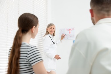 Photo of In vitro fertilization (IVF). Couple having consultation with doctor in reproductive clinic, selective focus