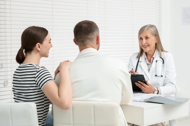 Photo of In vitro fertilization (IVF). Couple having consultation with doctor in reproductive clinic