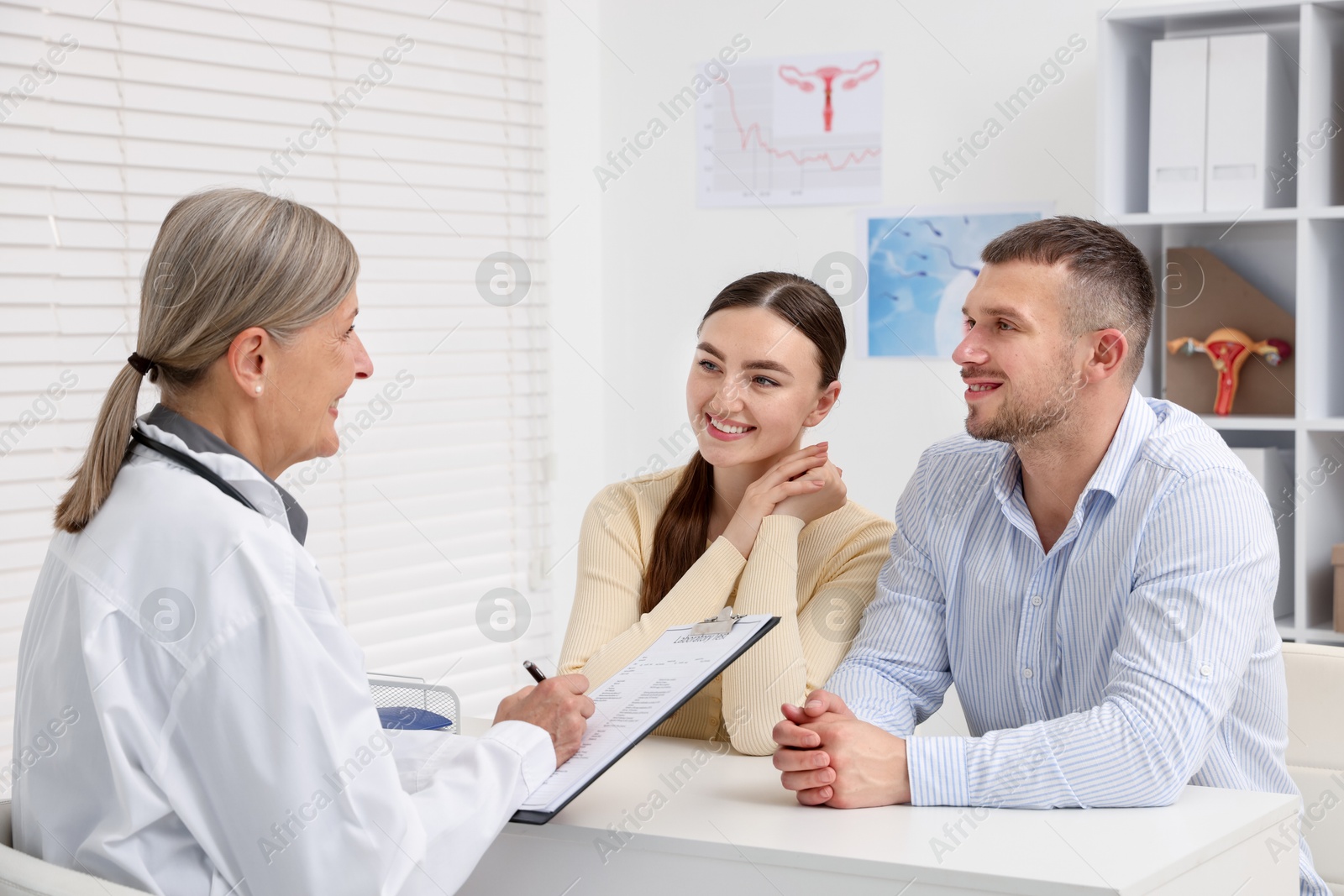 Photo of In vitro fertilization (IVF). Couple having consultation with doctor in reproductive clinic