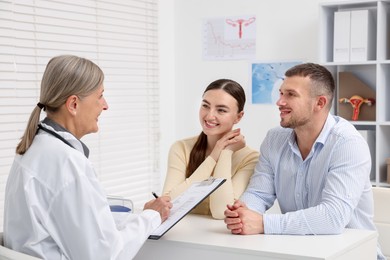Photo of In vitro fertilization (IVF). Couple having consultation with doctor in reproductive clinic