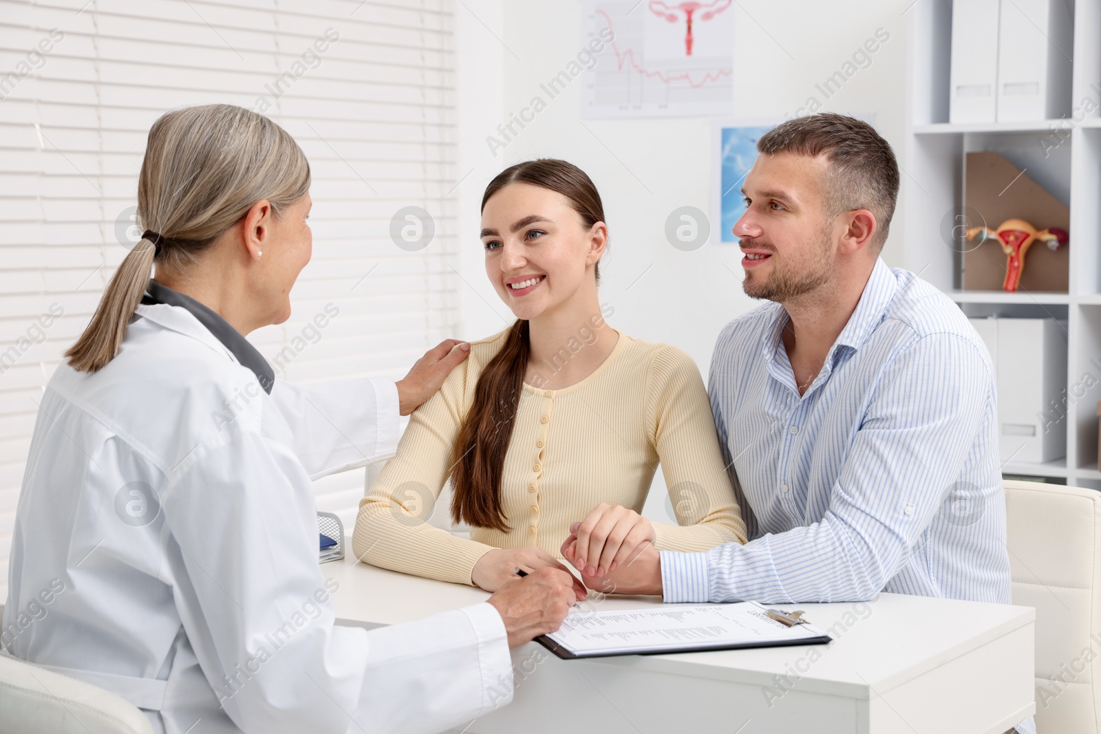 In vitro fertilization (IVF). Couple having consultation with doctor in reproductive clinic Photo of In vitro fertilization (IVF). Couple having consultation with doctor in reproductive clinic
