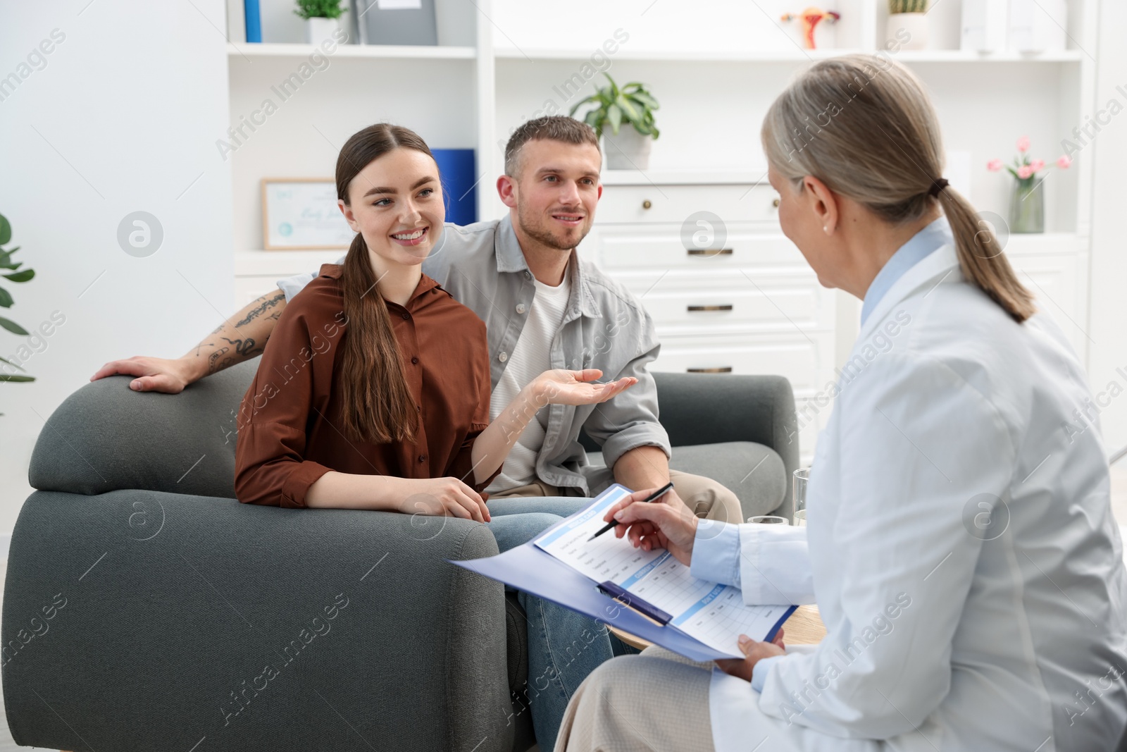 Photo of In vitro fertilization (IVF). Couple having consultation with doctor in reproductive clinic