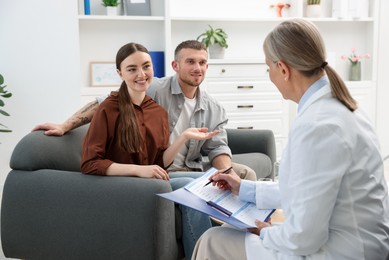 Photo of In vitro fertilization (IVF). Couple having consultation with doctor in reproductive clinic