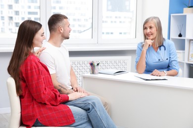 Photo of In vitro fertilization (IVF). Couple having consultation with doctor in reproductive clinic