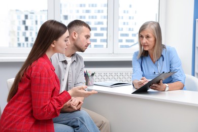 Photo of In vitro fertilization (IVF). Couple having consultation with doctor in reproductive clinic