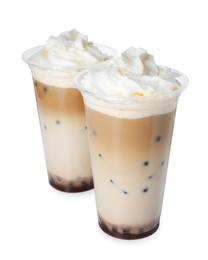 Photo of Tasty milk bubble tea in plastic cups isolated on white