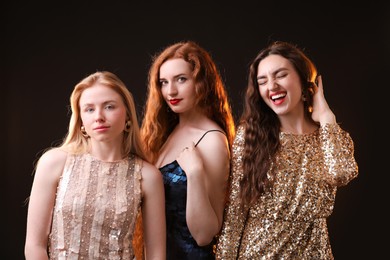 Photo of Beautiful women with different hair colors on dark background
