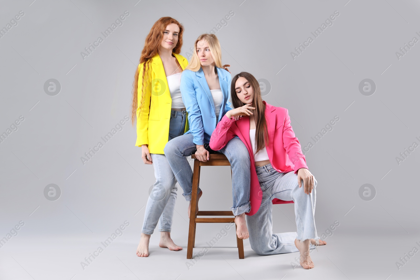 Photo of Beautiful women with different hair colors on light grey background