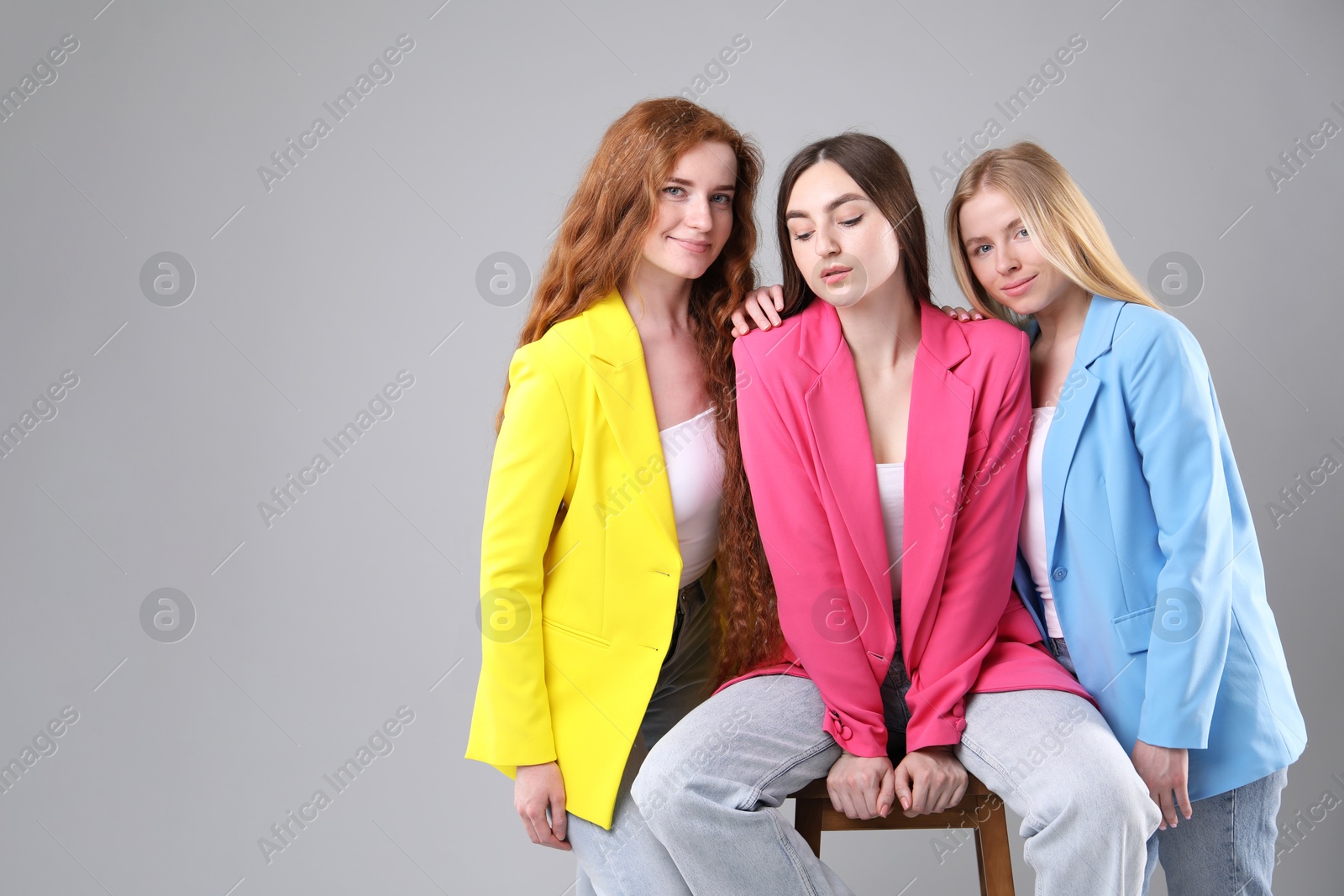 Beautiful women with different hair colors on light grey background, space for text Photo of Beautiful women with different hair colors on light grey background, space for text