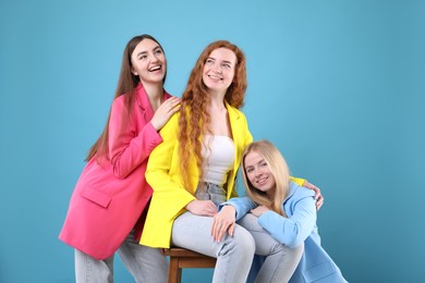 Photo of Beautiful women with different hair colors on light blue background