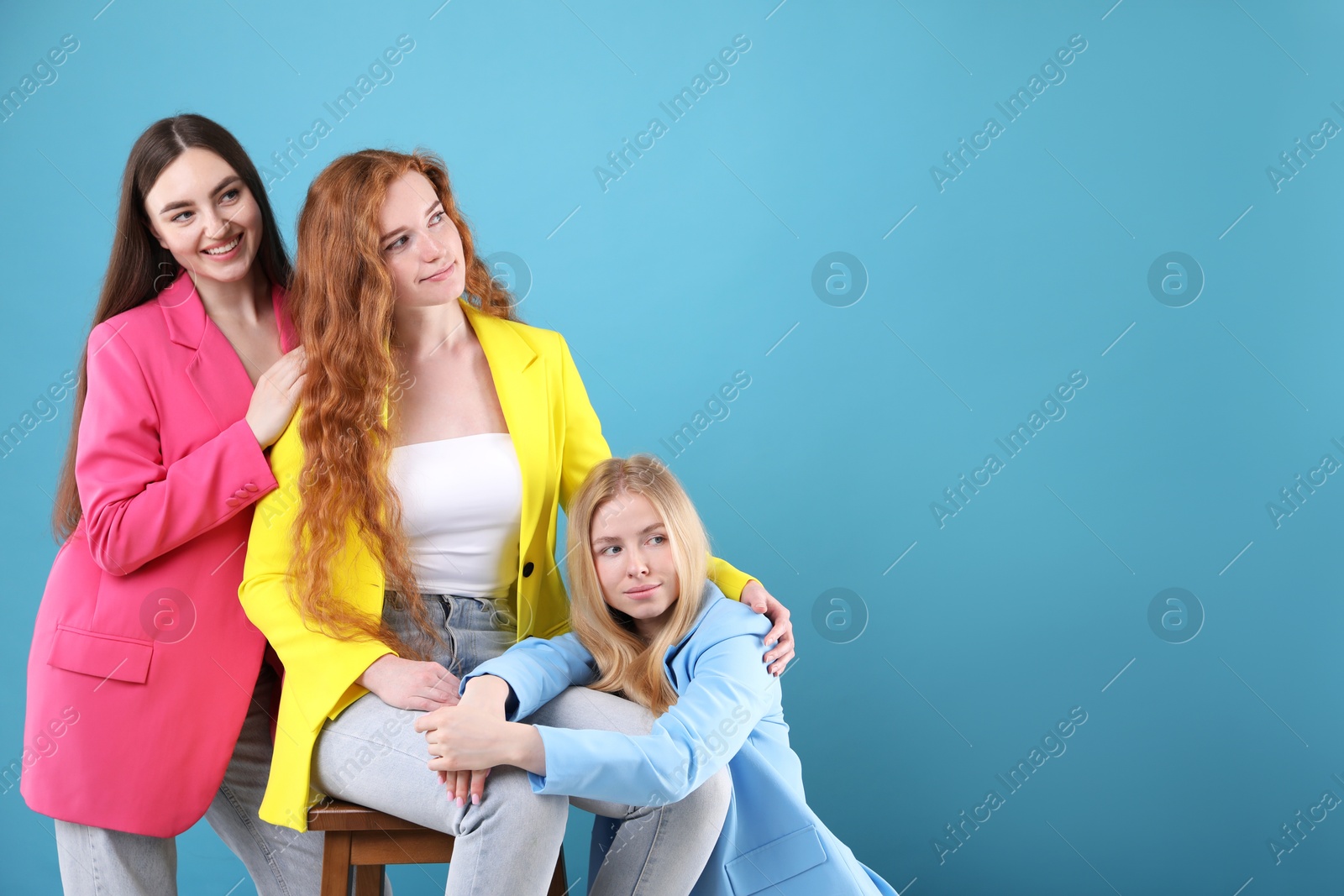 Beautiful women with different hair colors on light blue background, space for text Photo of Beautiful women with different hair colors on light blue background, space for text