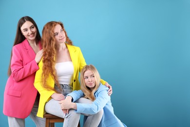 Photo of Beautiful women with different hair colors on light blue background, space for text
