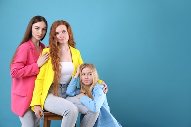 Photo of Beautiful women with different hair colors on light blue background, space for text