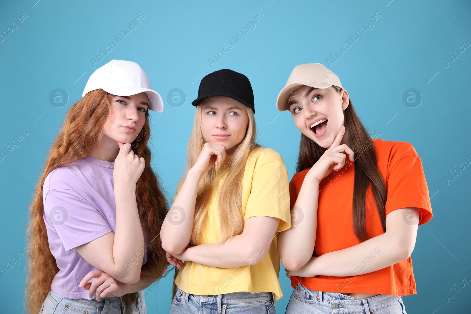 Beautiful women with different hair colors on light blue background Photo of Beautiful women with different hair colors on light blue background