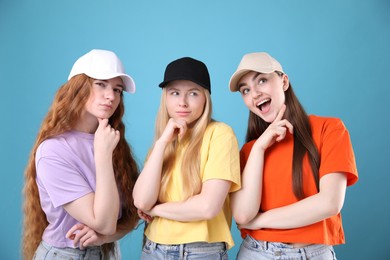 Photo of Beautiful women with different hair colors on light blue background