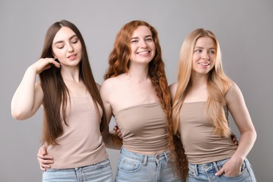 Photo of Beautiful women with different hair colors on grey background