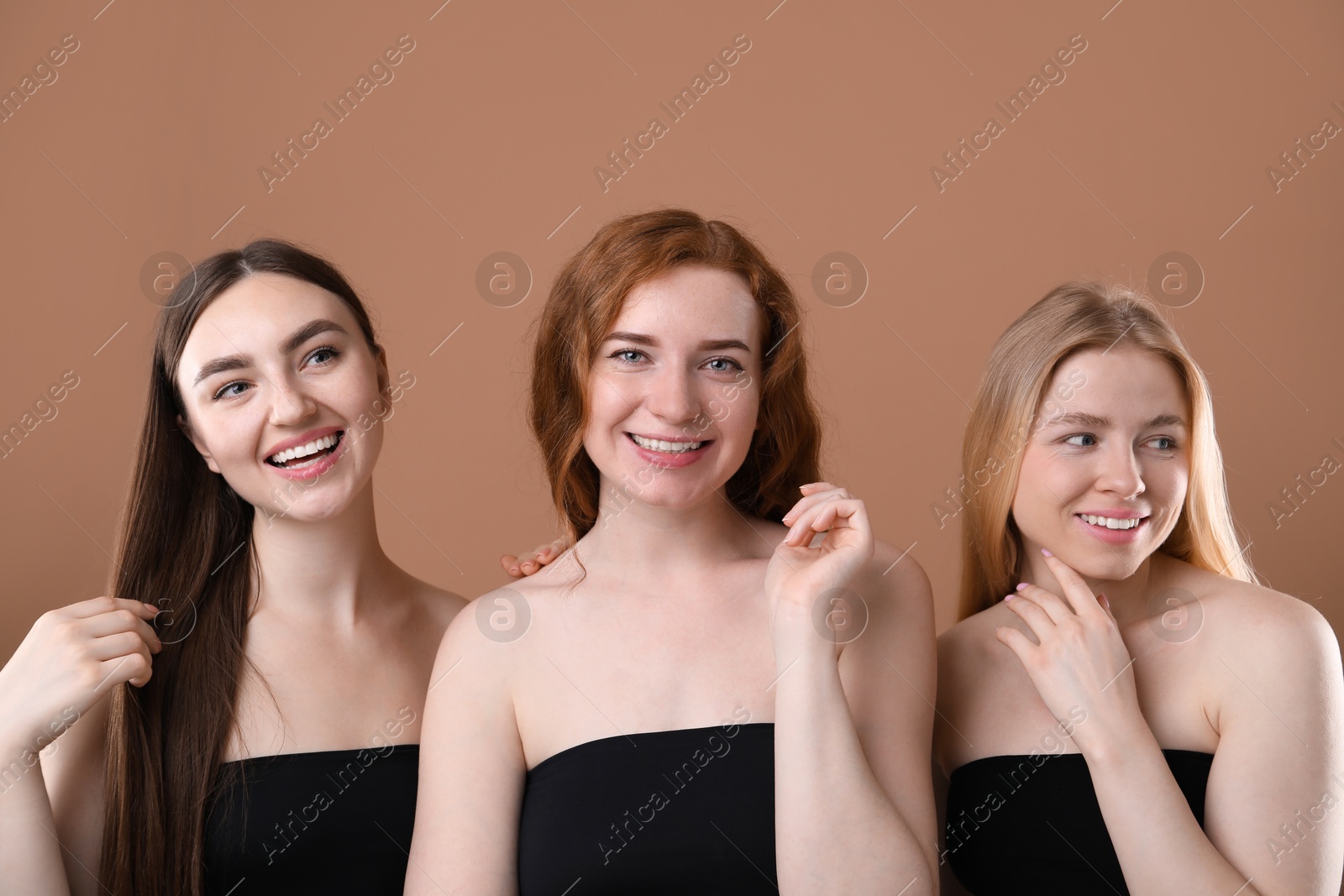 Photo of Beautiful women with different hair colors on dark beige background