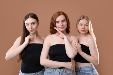 Photo of Beautiful women with different hair colors on dark beige background