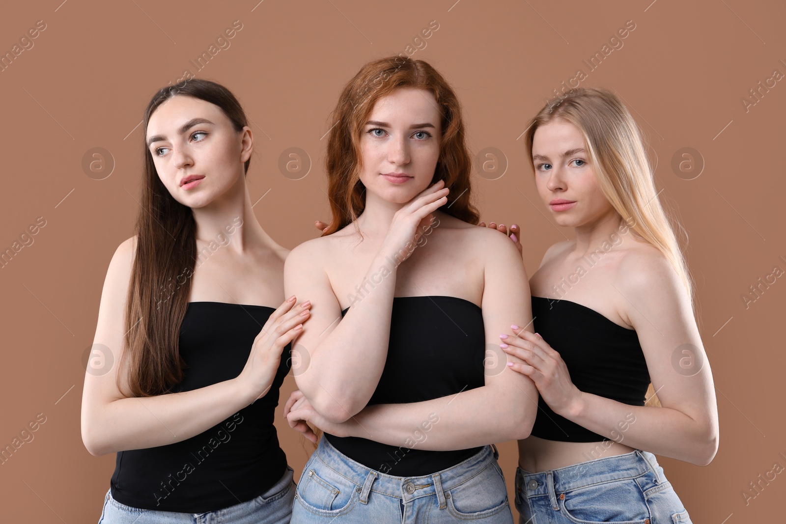 Beautiful women with different hair colors on dark beige background Photo of Beautiful women with different hair colors on dark beige background