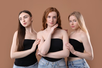 Photo of Beautiful women with different hair colors on dark beige background
