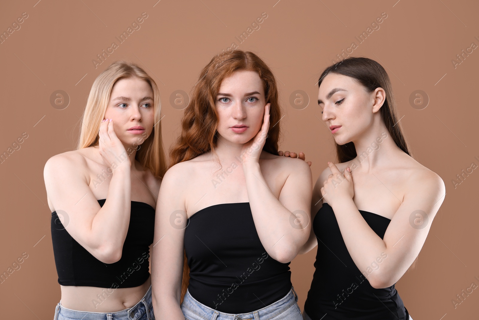 Beautiful women with different hair colors on dark beige background Photo of Beautiful women with different hair colors on dark beige background