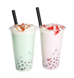 Photo of Tasty milk bubble tea in plastic cups isolated on white