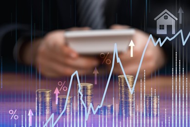 Image of Increase in real estate value. Graph with arrows, house icon and percent signs. Man using calculator at table with coins, selective focus