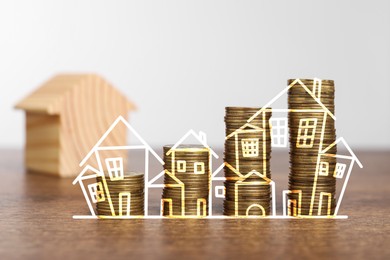 Image of Increase in real estate value. Stacked coins and illustration of house on table