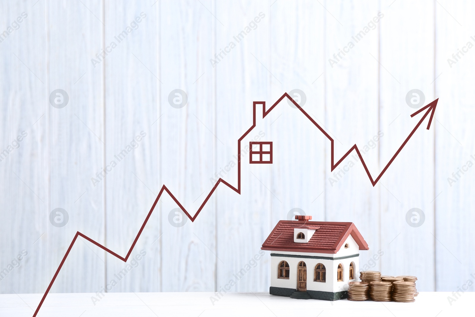 Increase in real estate value. House model and coins on table. Growing price represented by arrow Image of Increase in real estate value. House model and coins on table. Growing price represented by arrow