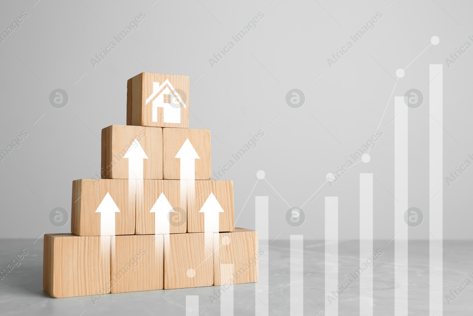 Increase in real estate value. Wooden cubes with arrows and house icon on table. Growing price represented by graph Image of Increase in real estate value. Wooden cubes with arrows and house icon on table. Growing price represented by graph