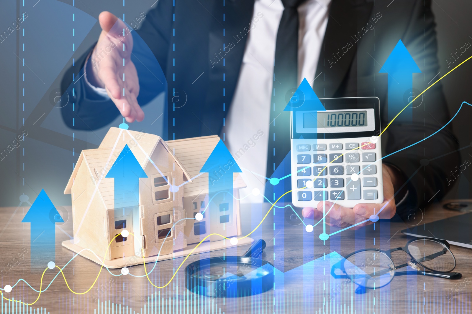 Increase in real estate value. Man pointing at house model and showing calculator, closeup. Graph with arrows Image of Increase in real estate value. Man pointing at house model and showing calculator, closeup. Graph with arrows