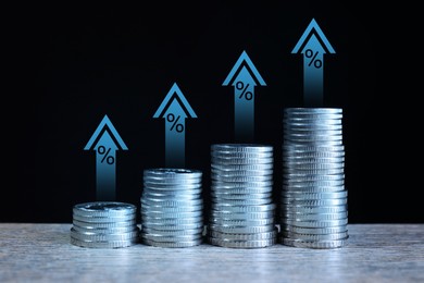 Image of Increase in real estate value. Stacked coins on table. Growing price represented by arrows and percent signs
