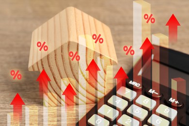 Image of Increase in real estate value. House model and calculator on table. Growing price represented by graph, percent signs and arrows